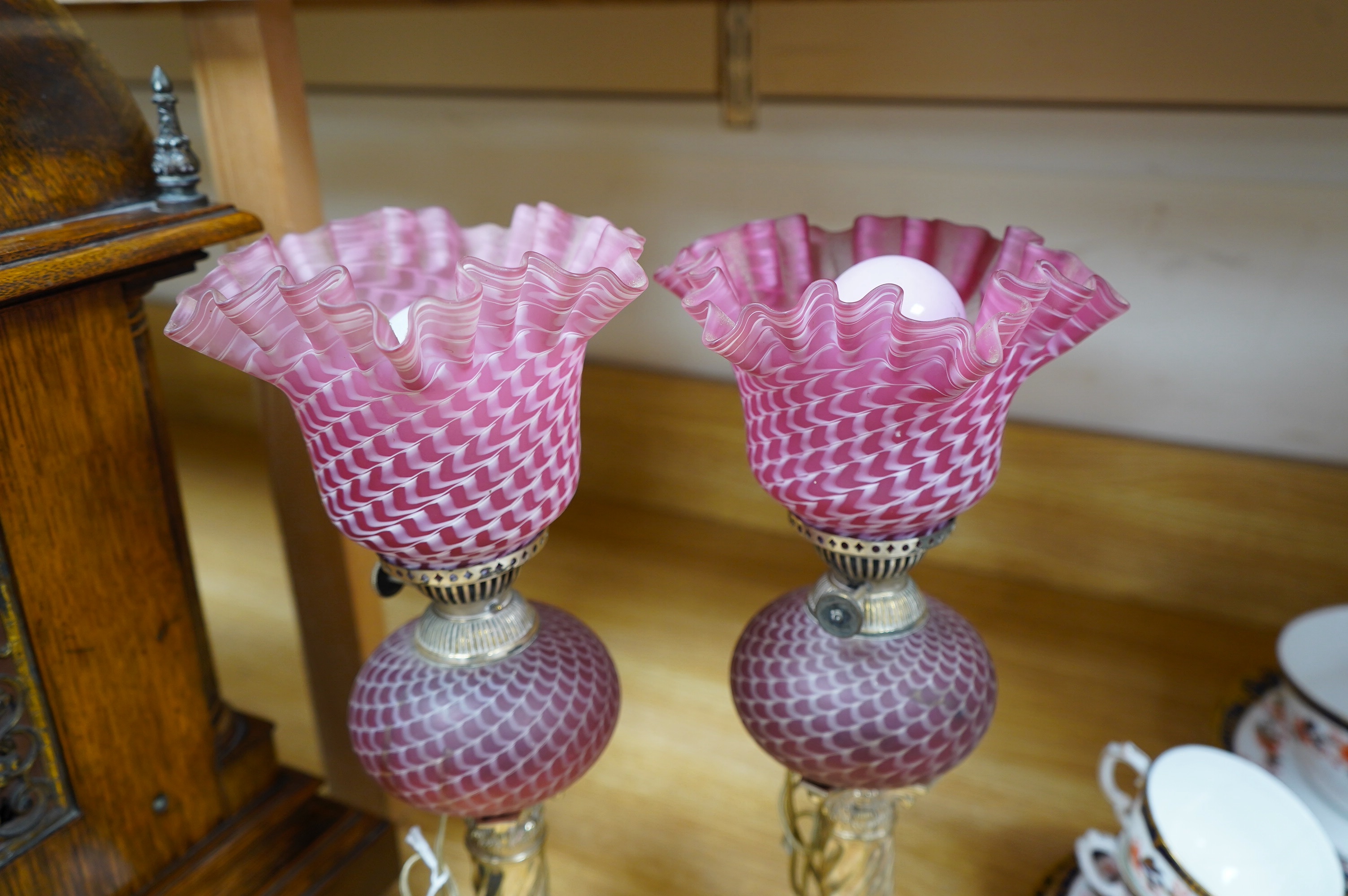 A pair of electroplate and ruby glass oil lamps, 35cm. Condition - good, not tested as working